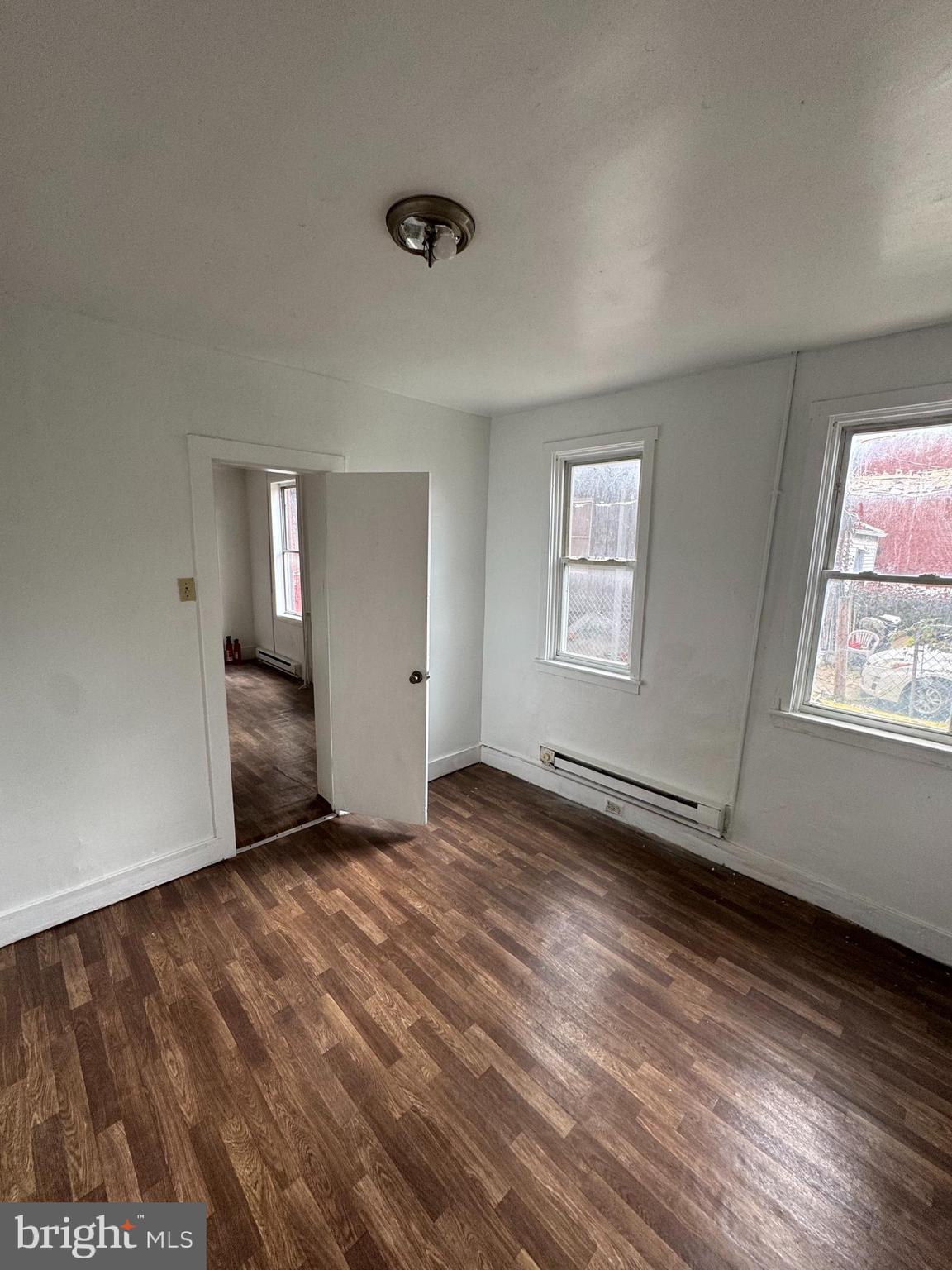 238 South 5th Street Reading, PA 19602 - Photo 24 of 28 an empty room with wooden floor and windows