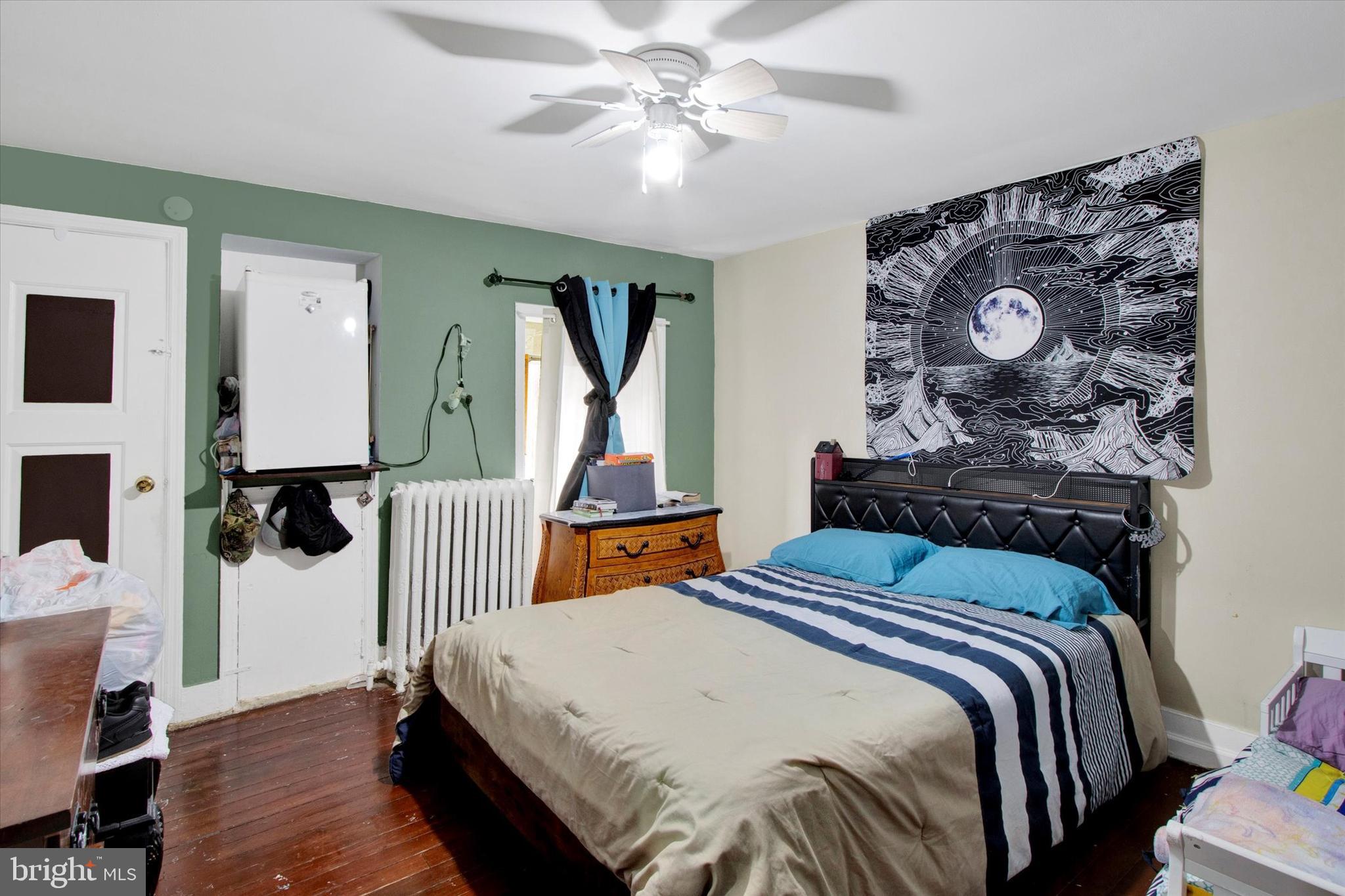 238 South 5th Street Reading, PA 19602 - Photo 7 of 28 a bedroom with bed and wooden floor