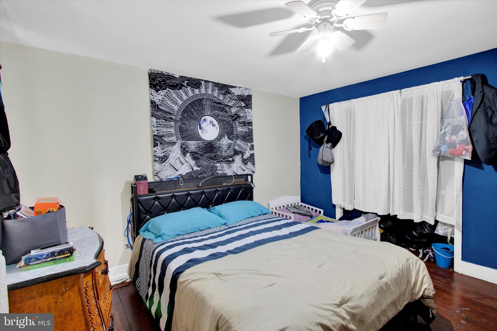 238 South 5th Street Reading, PA 19602 - Photo 8 of 28 a bedroom with a bed and a chandelier