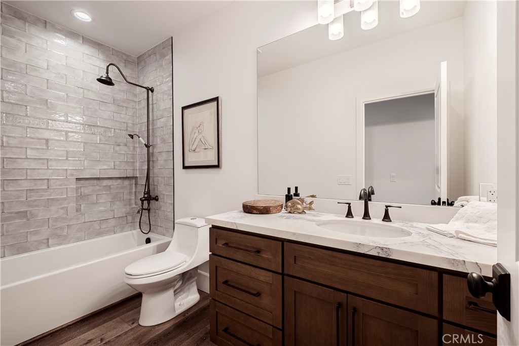 26868 Canyon End Road Canyon Country, CA 91387 - Photo 34 of 41 a bathroom with a bathtub shower sink vanity mirror and toilet