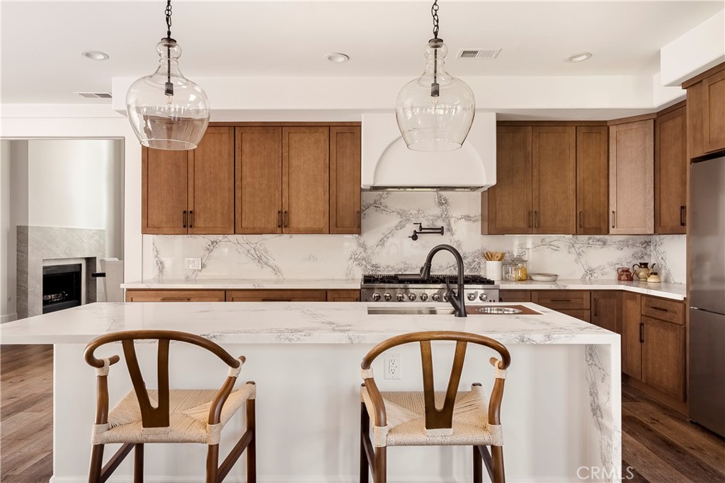 26868 Canyon End Road Canyon Country, CA 91387 - Photo 7 of 41 a kitchen with a table chairs stove and cabinets