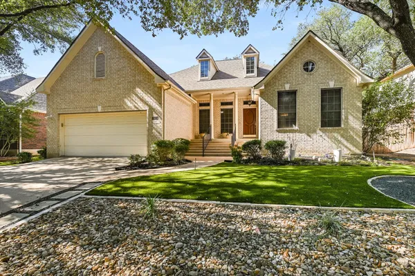 a front view of a house with garden