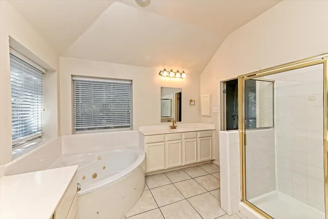 a bathroom with a tub sink and mirror