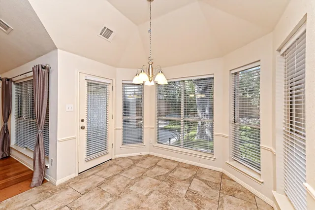 a large kitchen with granite countertop a stove and a sink