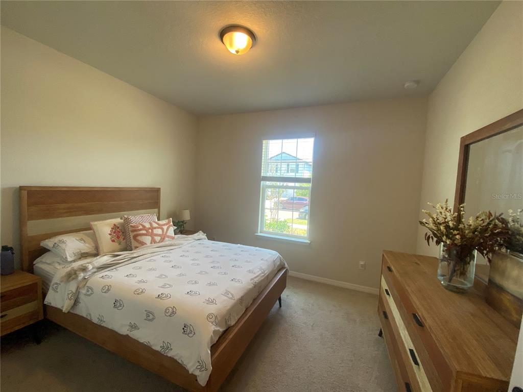9610 Rally Spring Loop Wesley Chapel, FL 33545 - Photo 14 of 38 a bedroom with a bed and window