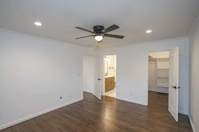 a view of a big room with wooden floor and a ceiling fan