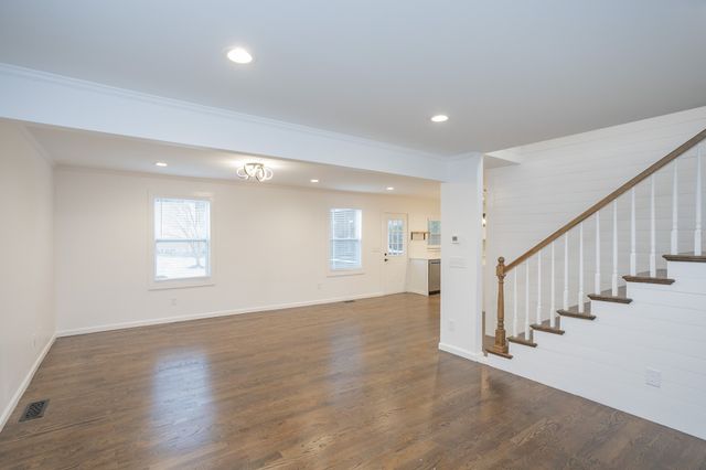 a view of an entryway with wooden floor