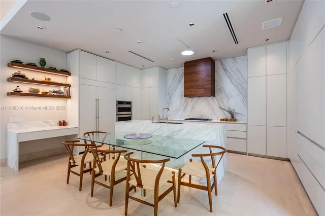 a living room with patio furniture and a floor to ceiling window