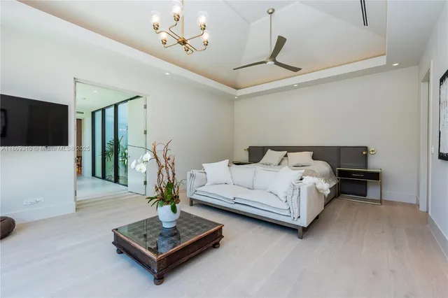 a bedroom with a bed and large window with balcony view