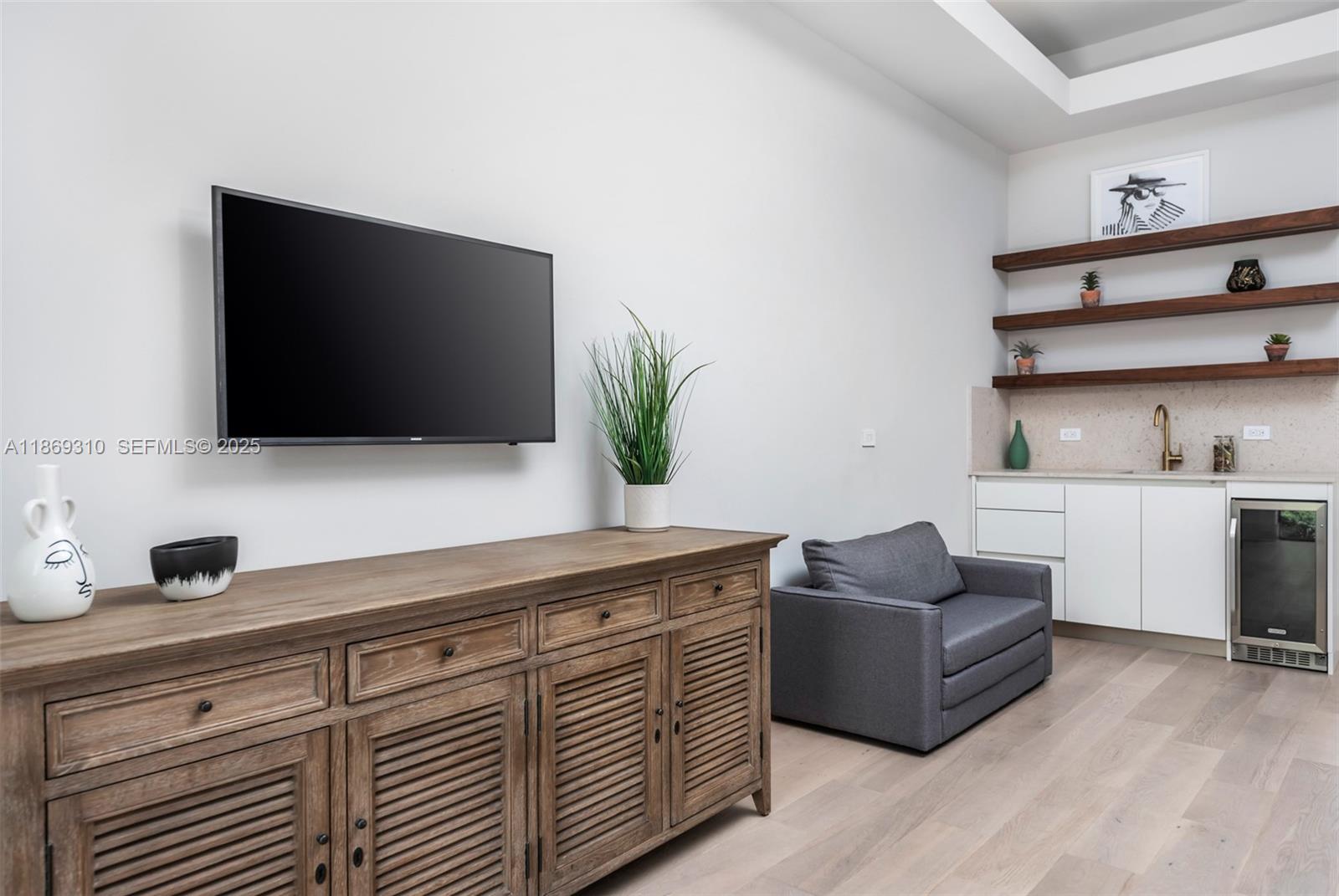 864 Northeast 84th Street Miami, FL 33138 - Photo 30 of 53 a living room with furniture and a flat screen tv