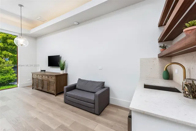 a bedroom with two beds and a potted plant