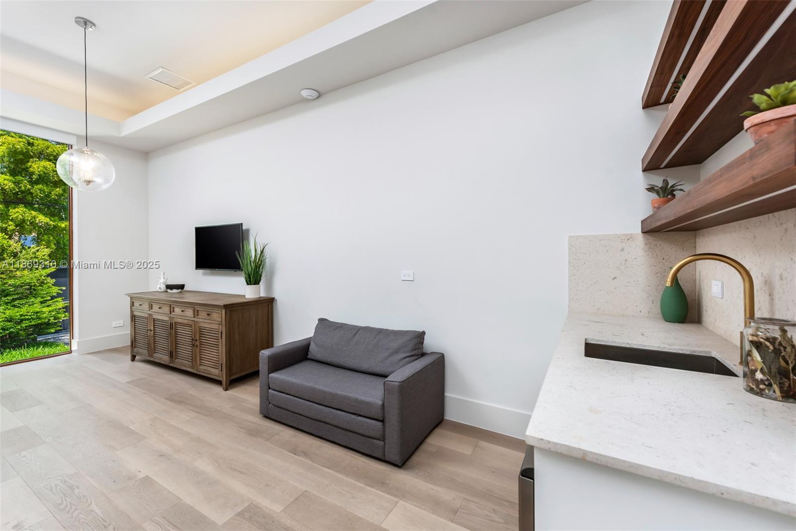 864 Northeast 84th Street Miami, FL 33138 - Photo 31 of 53 a living room with furniture and flat screen tv