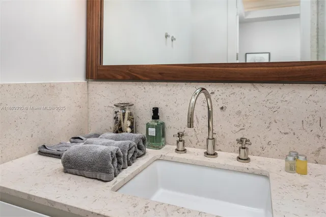a bathroom with a sink vanity and shower