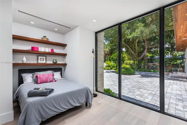 a bathroom with a granite countertop sink a toilet a mirror and shower