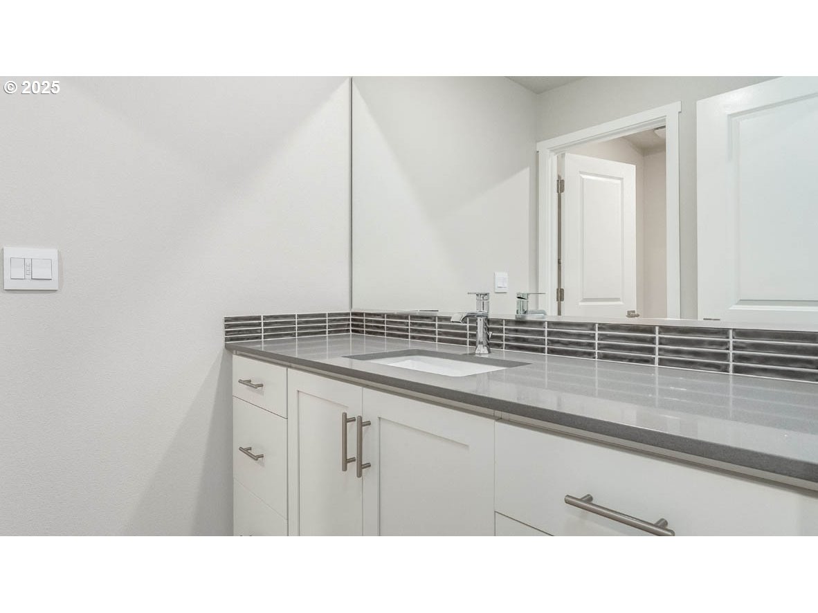 9355 Southeast Crystal Rose Street Happy Valley, OR 97086 - Photo 16 of 27 a bathroom with a sink and a mirror