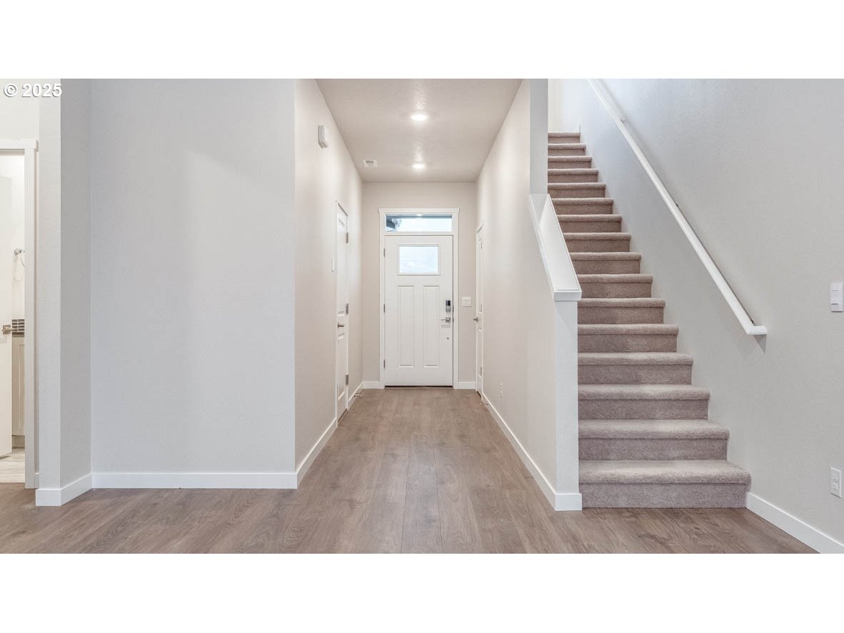 9355 Southeast Crystal Rose Street Happy Valley, OR 97086 - Photo 2 of 27 a open hall with stairs