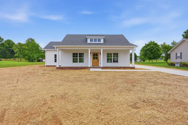 a front view of a house with a yard
