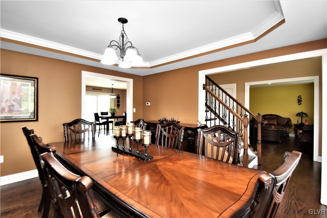249 East Dell Road Bath, PA 18014 - Photo 15 of 50 a dining room with wooden floor a chandelier a wooden table and chairs