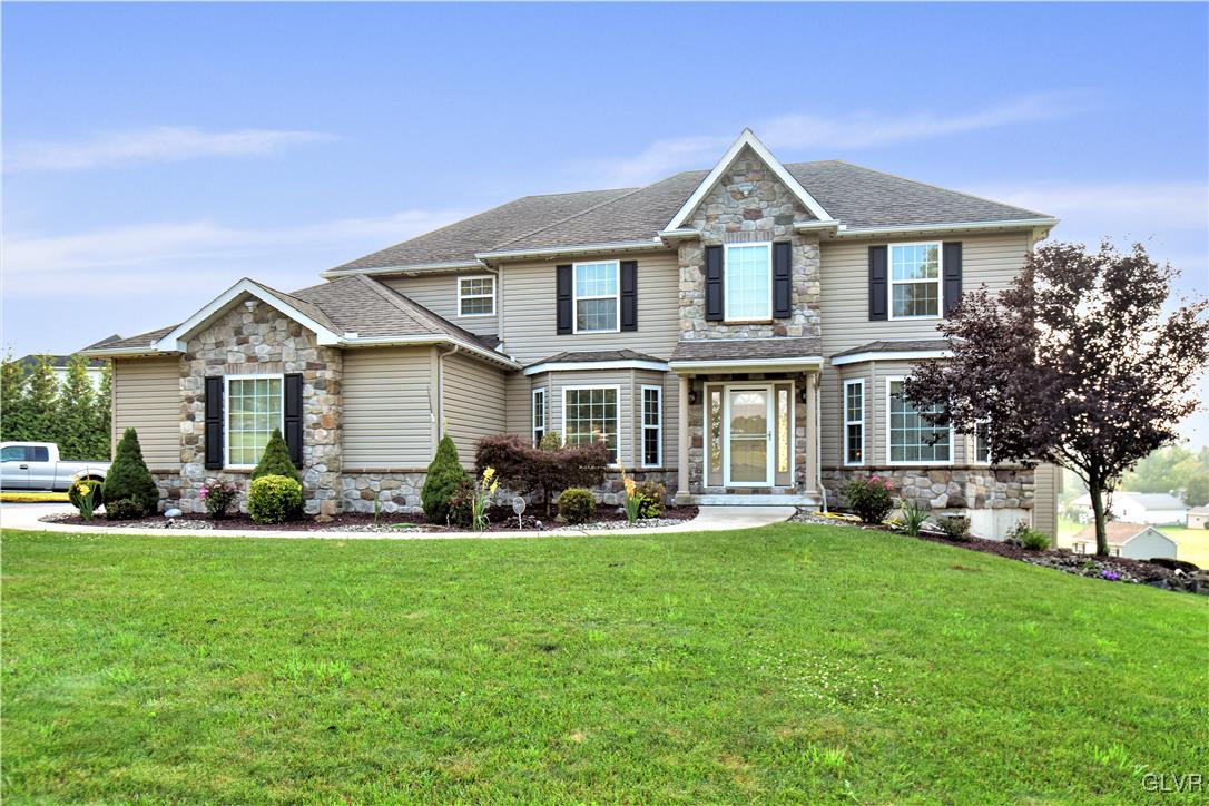 249 East Dell Road Bath, PA 18014 - Photo 2 of 50 a front view of a house with a garden and yard