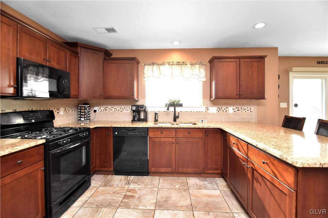 249 East Dell Road Bath, PA 18014 - Photo 24 of 50 a kitchen with a sink stove top oven and cabinets