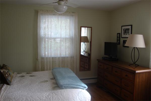 39 Carr Street Sutton, MA 01590 - Photo 13 of 24 a bedroom with a bed and a mirror on dresser