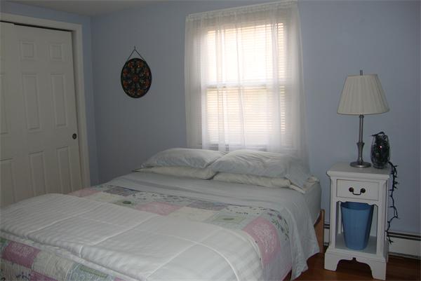 39 Carr Street Sutton, MA 01590 - Photo 15 of 24 a bedroom with a bed a fireplace and a window