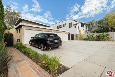 a view of a car parked in front of a house