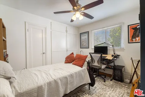 a bedroom with a bed and a desk