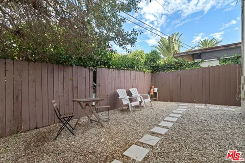 a view of backyard with a table and chairs