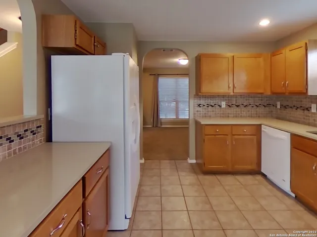 a kitchen with a cabinets and a refrigerator