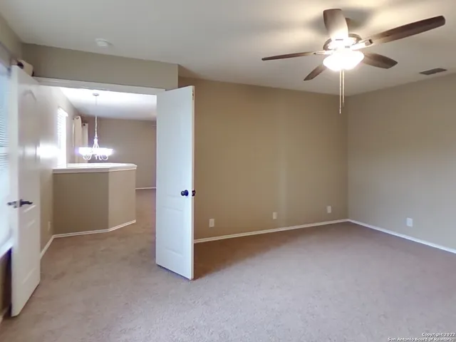 a view of a kitchen with a sink and a chandelier fan