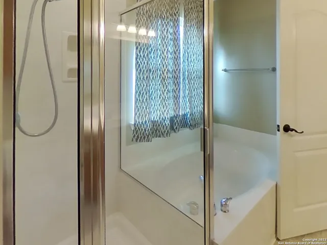 a bathroom with a glass shower door