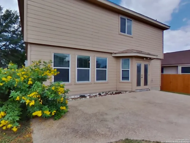 a front view of house with flowers