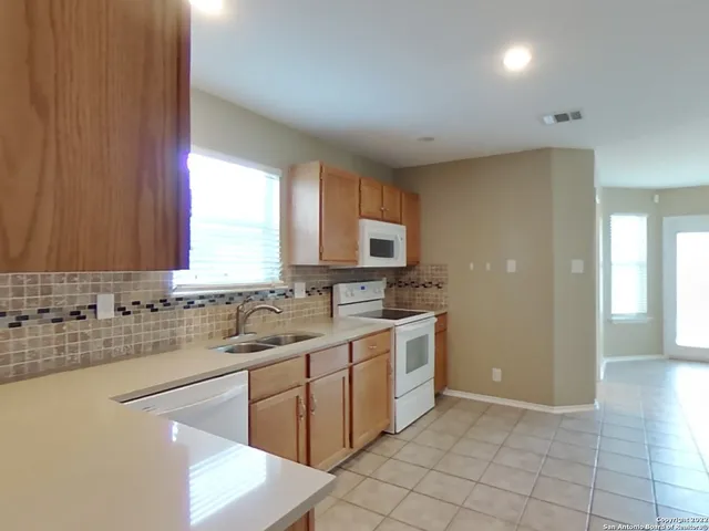 a kitchen with a sink cabinets and window