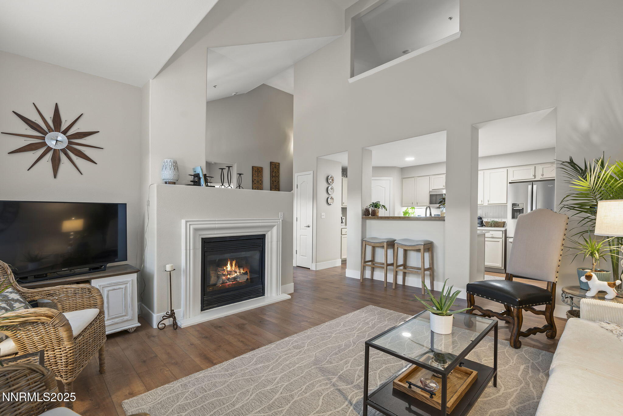 9050 Double R Boulevard, Unit 1122 Reno, NV 89521 - Photo 3 of 20 a living room with furniture a flat screen tv and a fireplace