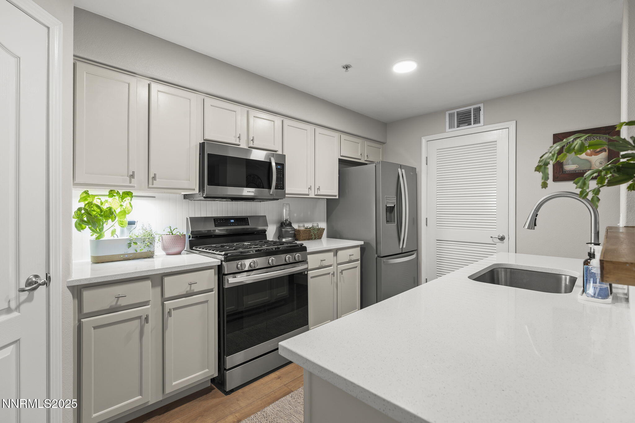 9050 Double R Boulevard, Unit 1122 Reno, NV 89521 - Photo 6 of 20 a kitchen with a sink a stove and refrigerator