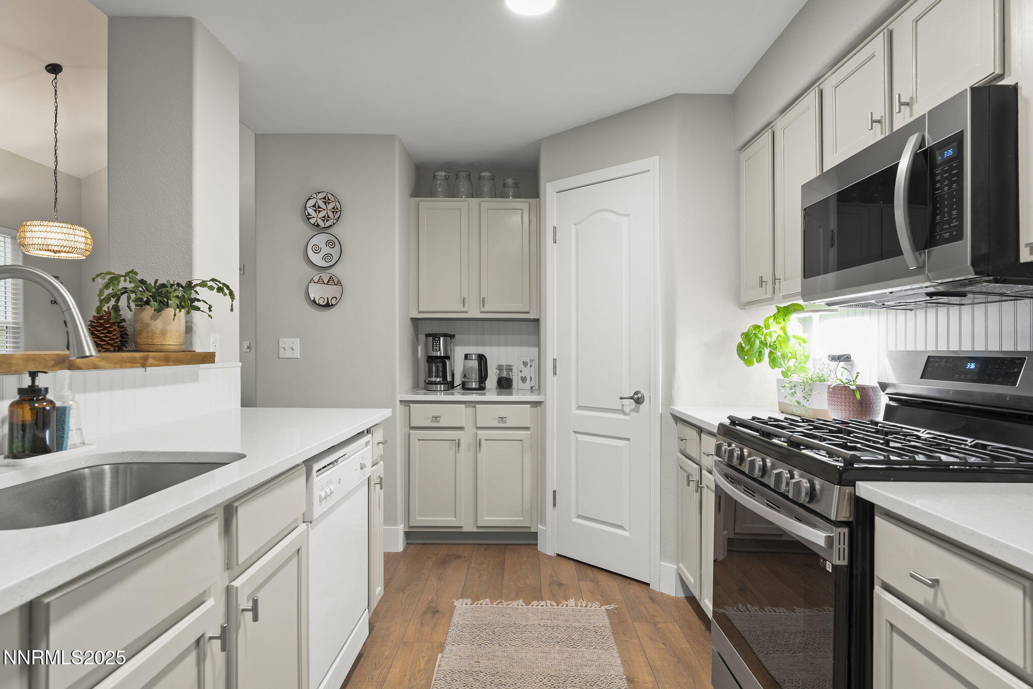 9050 Double R Boulevard, Unit 1122 Reno, NV 89521 - Photo 8 of 20 a kitchen with stainless steel appliances a stove a sink and a microwave