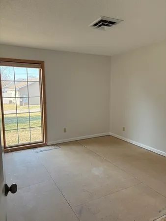 a view of an empty room with a window