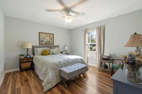 a bedroom with a bed and wooden floor