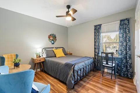 a bedroom with a bed and a chandelier