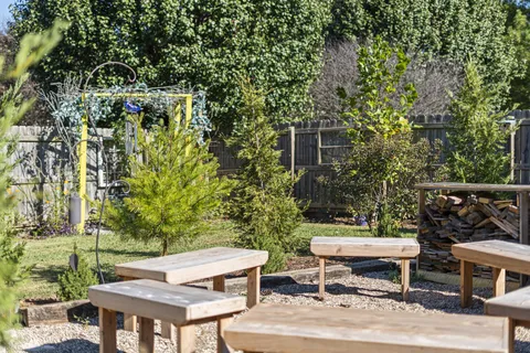 a view of a patio with table and chairs and potted plants