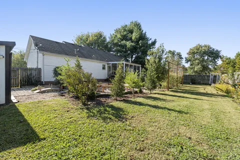 a house view with swimming pool in front of it