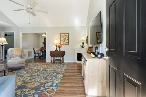 a living room with furniture and a chandelier