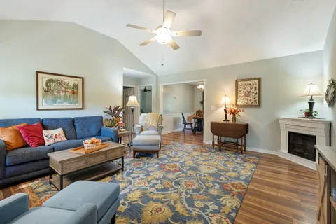 a living room with furniture two lamps and a fireplace
