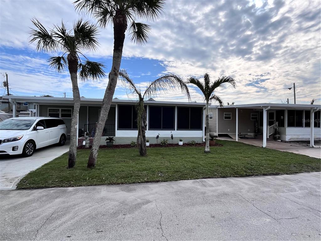 2295 North Beach Road, Unit 23 Englewood, FL 34223 - Photo 4 of 20 a view of a yard in front of house