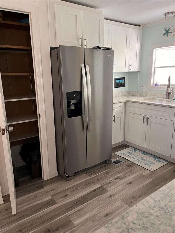 2295 North Beach Road, Unit 23 Englewood, FL 34223 - Photo 7 of 20 a kitchen with stainless steel appliances a refrigerator and cabinets