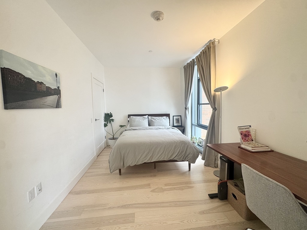 32 Traveler Street, Unit 609 Boston, MA 02118 - Photo 13 of 26 a bedroom with a bed and flat screen tv