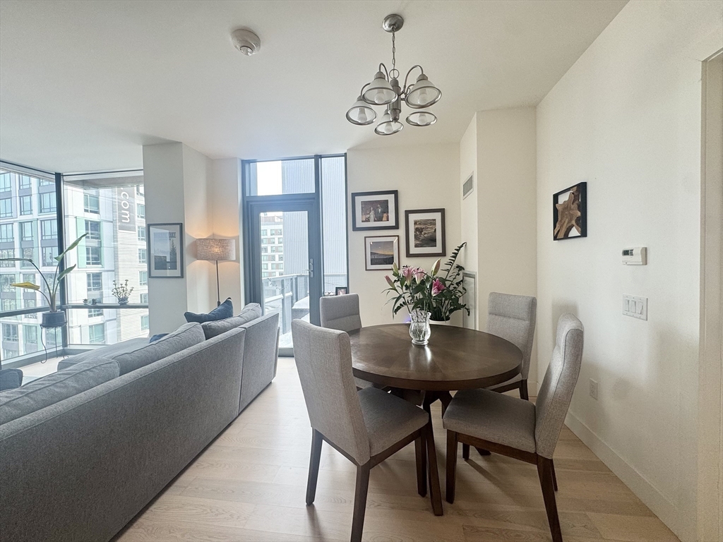 32 Traveler Street, Unit 609 Boston, MA 02118 - Photo 5 of 26 a dining room with furniture a chandelier and window
