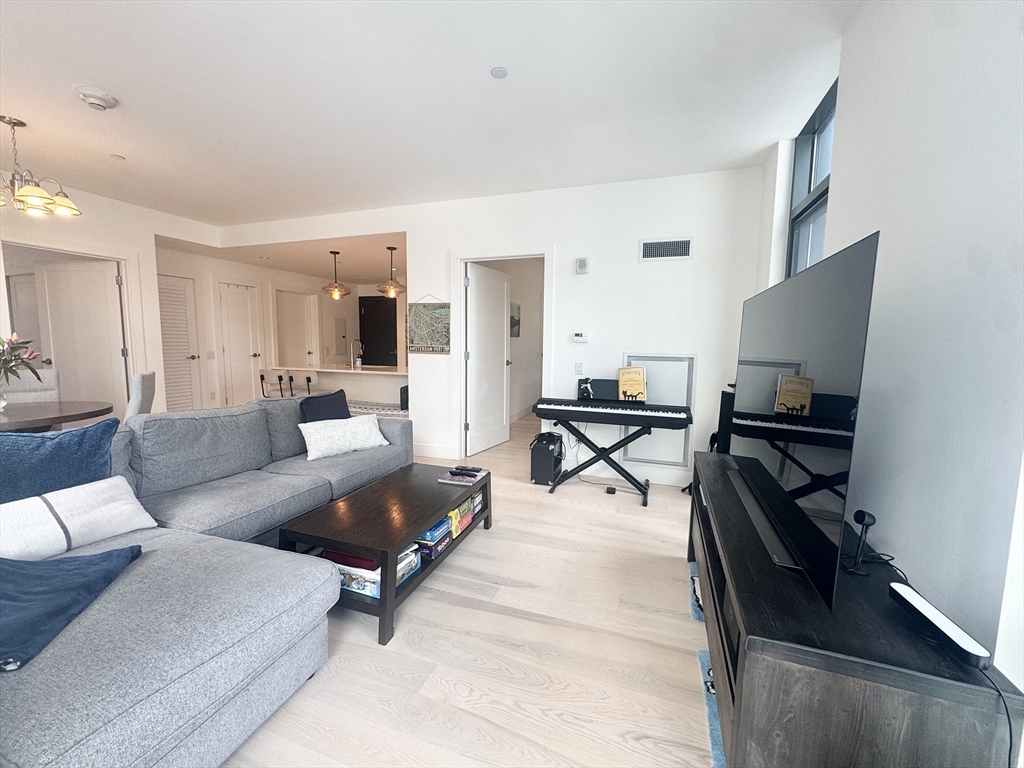 32 Traveler Street, Unit 609 Boston, MA 02118 - Photo 7 of 26 a living room with furniture and a flat screen tv