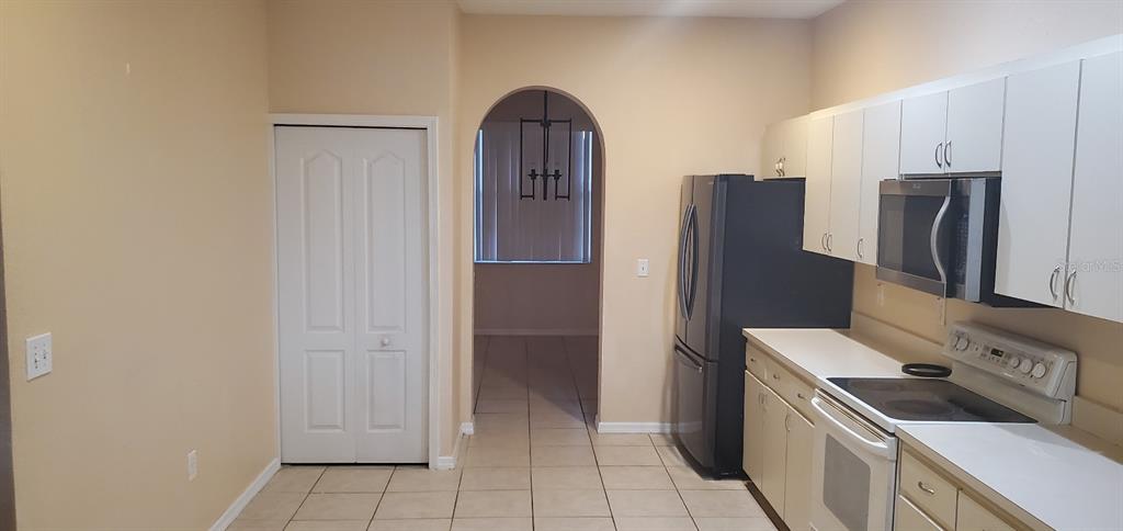 810 Terranova Road Winter Haven, FL 33884 - Photo 2 of 10 a kitchen with stainless steel appliances granite countertop a refrigerator and a stove